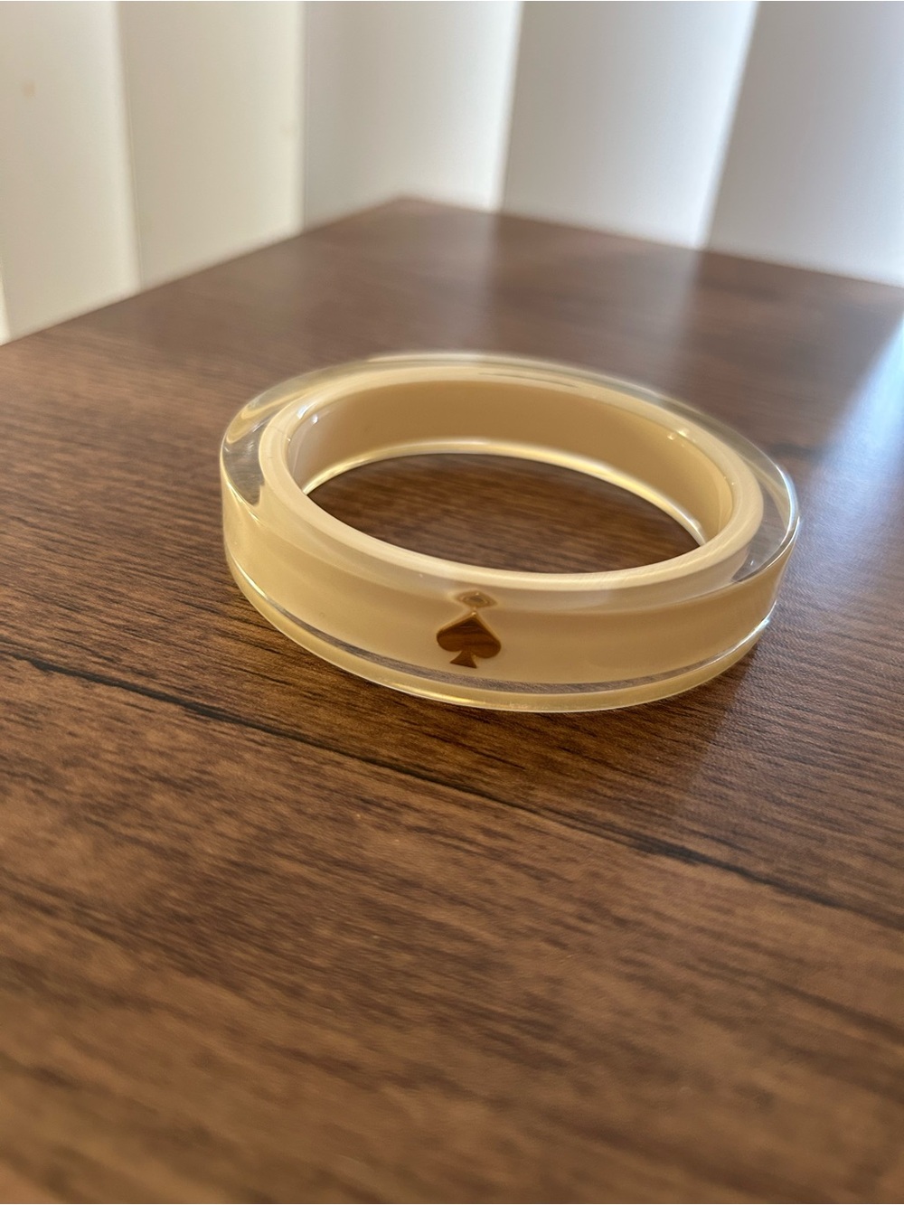 Kate Spade New York gold spade inside cream color acrylic bangle bracelet